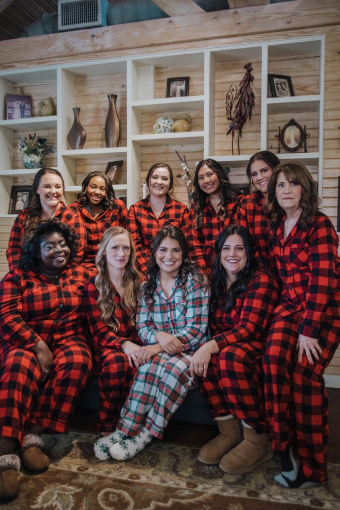 Hollow Hill Event Center Wedding and Event Venue, Weatherford, Texas. Bride and bridesmaids in flannel pj's with bookshelf behind them.